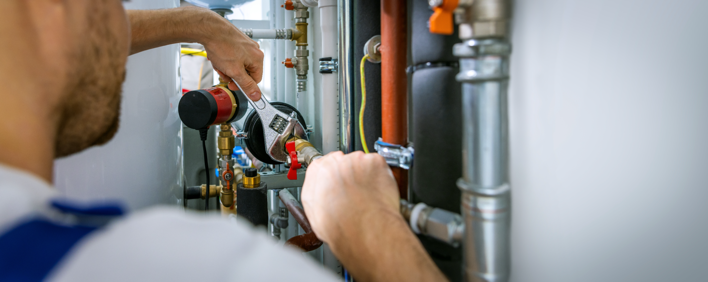 Plumber installing a whole-house water filtration cartridge in an Inland Empire home